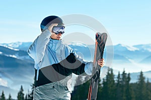 Portrait of a skier in the ski resort on the background of mountains and blue sky, Bukovel.