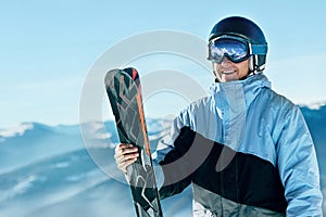 Portrait of a skier in the ski resort on the background of mountains and blue sky, Bukovel.