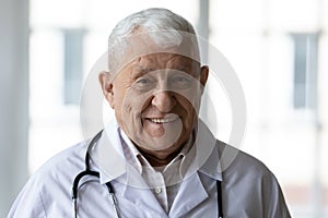 Portrait of skilled experienced trustful elderly 70s general practitioner. photo