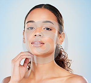 Portrait, skincare and beauty of confident woman in studio for glow, shine or health isolated on blue background. Face