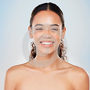 Portrait, skincare and beauty of happy woman in studio for glow, shine or health isolated on blue background. Face