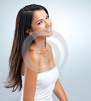 Portrait, skincare and beauty of Latina model by gray background with flawless skin, radiant complexion and elegance