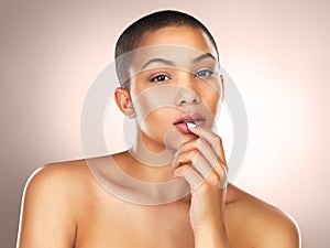 Portrait, skincare and beauty of serious woman in makeup for wellness or health in studio isolated on brown background