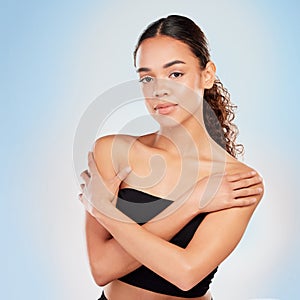 Portrait, skincare and beauty of woman for body glow, shine or health isolated on blue studio background. Face, touch
