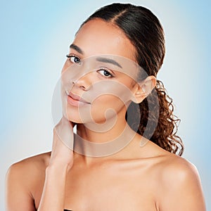 Portrait, skincare and beauty of woman in studio for glow, shine or health isolated on blue background. Face, touch and