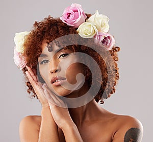 Portrait, skincare and flowers with a model woman in studio on a gray background for natural beauty. Wellness, luxury