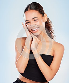 Portrait, skincare and happy woman in makeup for glow, shine or health isolated on blue studio background. Face, touch