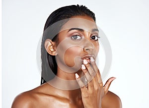 Portrait, skincare and Indian woman in makeup at studio for wellness for glow isolated on a white background in spa