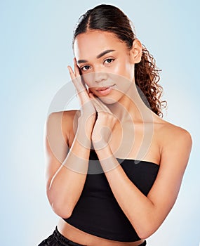 Portrait, skincare and woman in makeup for glow, shine or health isolated on blue studio background. Face, touch and