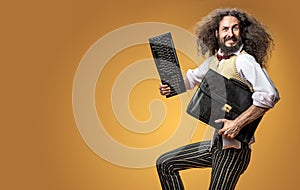 Portrait of a skinny nerd holding a keyboard and a briefcase