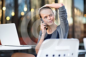 Portrait of a sleek young woman calling on a smartphone