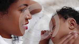 Portrait of sleeping african american baby girl with mother