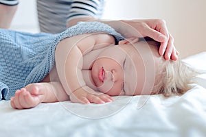 Portrait of a sleeping baby, mom put the baby to daytime sleep