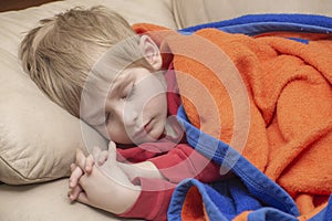 Portrait of a sleeping blonde caucasian male folding hands