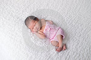 Newborn Baby Girl Wearing a Pink Romper photo