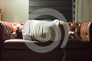 Portrait of sleeping thoughtful man on vintage sofa in the living room photo