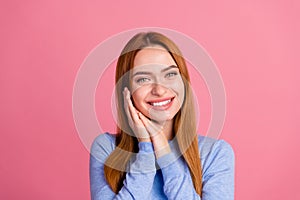 Portrait of sleepy dreamy cheerful girl with foxy hairdo wear blue pullover holding palms on cheeks isolated on pink