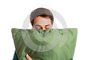 Portrait of a sleepyhead man in pajamas with its beloved pillow