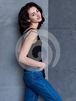 Portrait of slim young Caucasian woman turning back to camera smiling and looking flirty