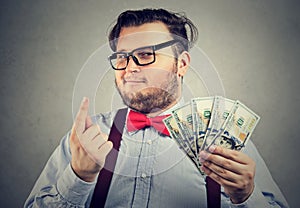 Portrait of a sly looking businessman with hundred dollar bills photo
