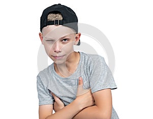 Portrait of a sly squinting teenage boy in a baseball cap, isolated on white background.