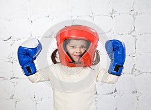 Portrait of the small dark-haired girl in a protective helmet an