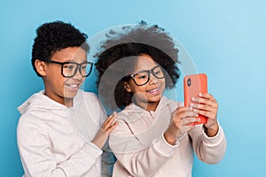 Portrait of small little friends friendship trendy cheery pre-teen kids taking selfie  over bright blue color