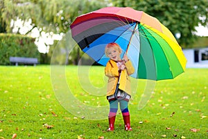 Portrait of small preschooler girl with colorful umbrella