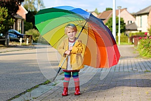 Portrait of small preschooler girl with colorful umbrella
