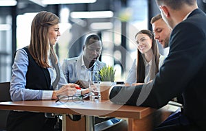 Portrait of smart business partners planning work at meeting