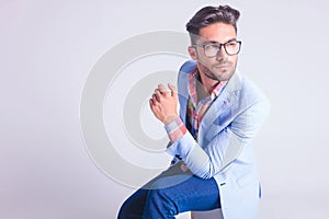Portrait of smart casual man wearing glasses, seated