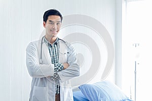 Portrait of a smart doctor standing in the medical room wait for diagnosing patient and treatment in new concept modern medicine