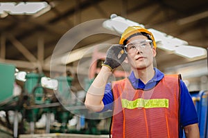 Portrait of smart engineer Asian Chinese happy labor worker handsome model in heavy industry  background.hand at protection