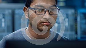 Portrait of a Smart and Handsome Software Developer Wearing Glasses Working on a Personal Computer