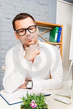 Portrait of smart minded businessman in glasses thinking about new project