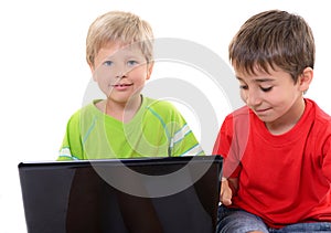 Portrait of smart schoolboys looking at the laptop, over white photo