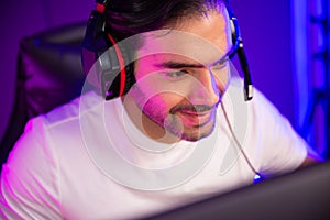 Portrait smart streamer talking with team player using headset and mic. Surmise.