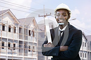 Portrait of smile african industrial engineer manager standing with the building in background