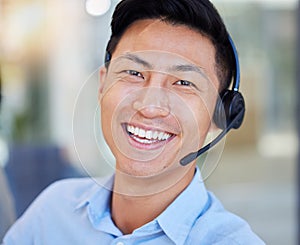 Portrait, smile and an asian man in a call center for customer service, support or lead generation. Face, contact and