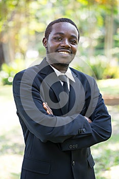 Portrait of smile business african man on nature background