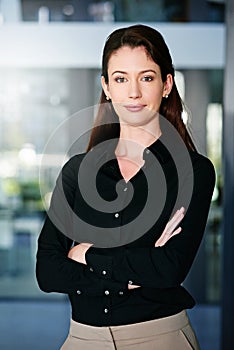 Portrait, smile and business woman with arms crossed in office, proud or positive attitude. Content editor, employee and