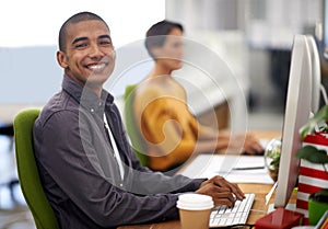 Portrait, smile and computer for happy employee, office and typing at desk in workspace. Technology, keyboard and