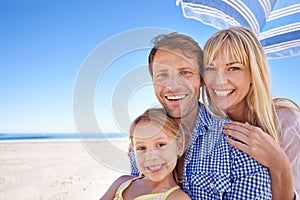 Portrait, smile and family at beach with umbrella, mockup space and tropical holiday adventure together. Happy mother