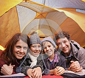 Portrait, smile and family camping in tent on vacation, holiday or travel together. Face, parents and happy children at