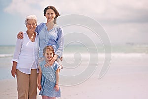 Portrait, smile and family generations on beach in summer together for travel, holiday or vacation. Senior mother, woman