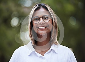 Portrait, smile and glasses with a woman in nature, outdoor on a green background for travel or freedom. Face, eyewear