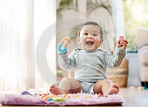 Portrait, smile and happy baby with toys on floor for fun, playing and game at home. Face, excited and toddler boy with