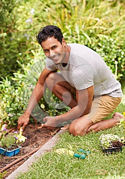 Portrait, smile and man in a garden, sunshine and summer with earth and grass with weekend break. Person, outdoor and