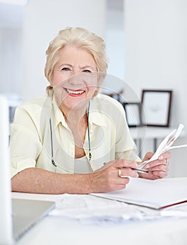 Portrait, smile and old woman with budget documents, savings and taxes in home. Financial planning, face and retirement