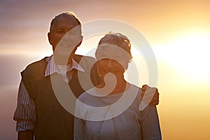 Portrait, smile and senior couple at sunset for love, romance or retirement bonding outdoor together. Face, autumn or